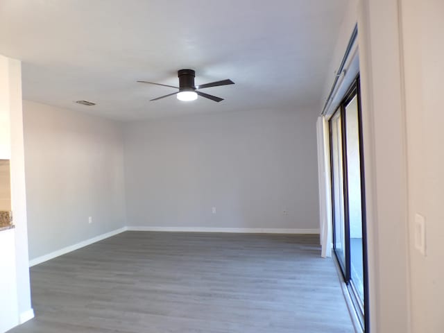 unfurnished room with ceiling fan, a healthy amount of sunlight, and wood-type flooring