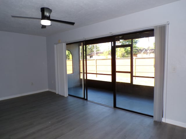 interior space with dark hardwood / wood-style flooring and ceiling fan