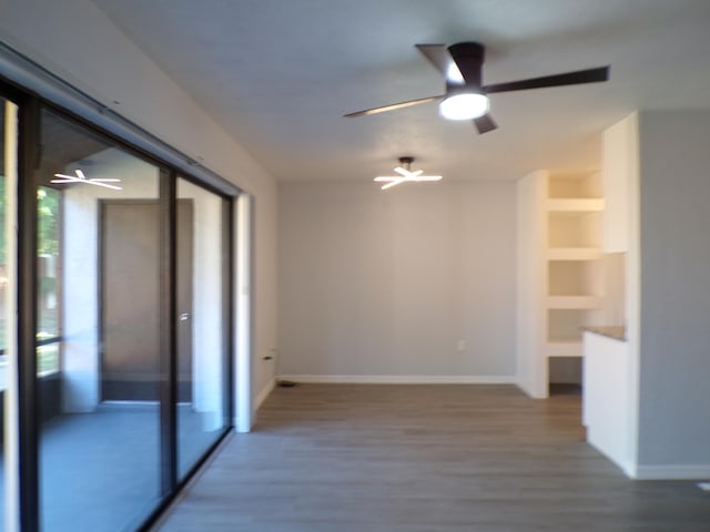 empty room featuring wood-type flooring and ceiling fan