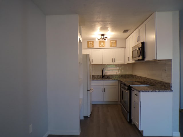 kitchen with white refrigerator, dark wood-type flooring, white cabinets, and electric stove