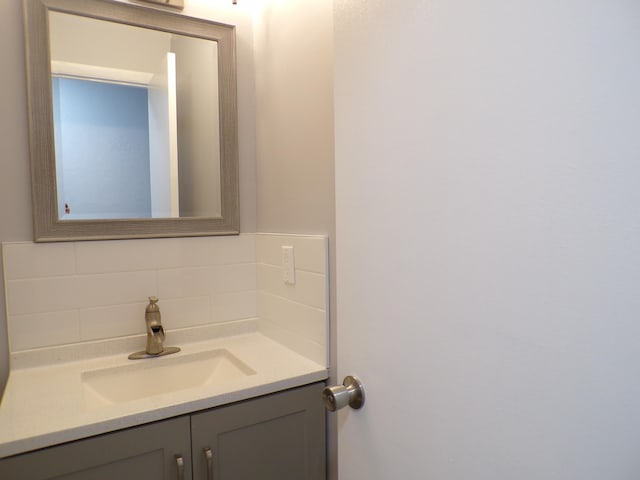 bathroom with backsplash and vanity