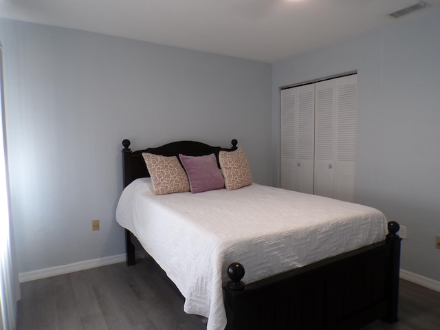 bedroom with a closet and dark hardwood / wood-style flooring