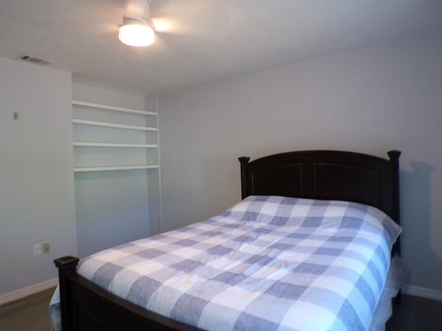 bedroom featuring dark wood-type flooring