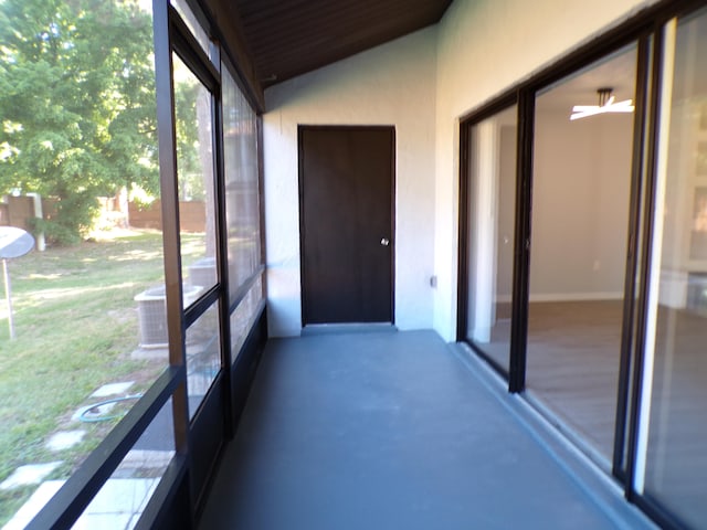 unfurnished sunroom featuring vaulted ceiling