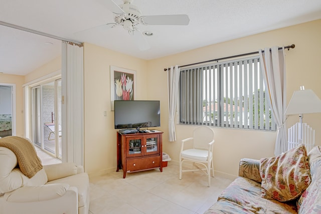 tiled living room featuring ceiling fan