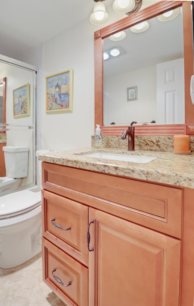 bathroom featuring tile patterned floors, vanity, and toilet