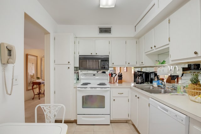 kitchen featuring white appliances, sink, light tile patterned floors, and white cabinets