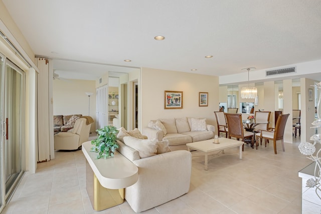 living room featuring a notable chandelier and light tile patterned flooring