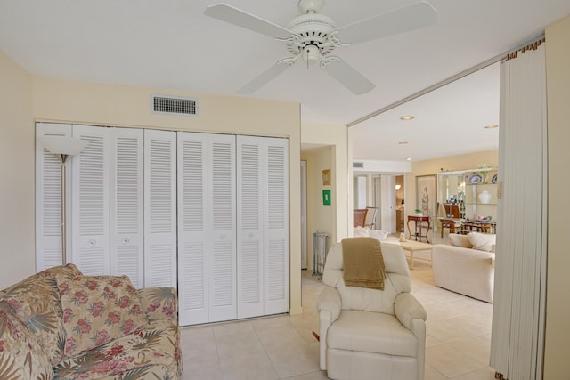 sitting room featuring ceiling fan and light tile patterned flooring