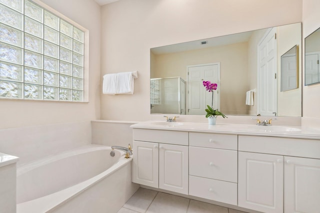 bathroom with shower with separate bathtub, double vanity, and tile flooring