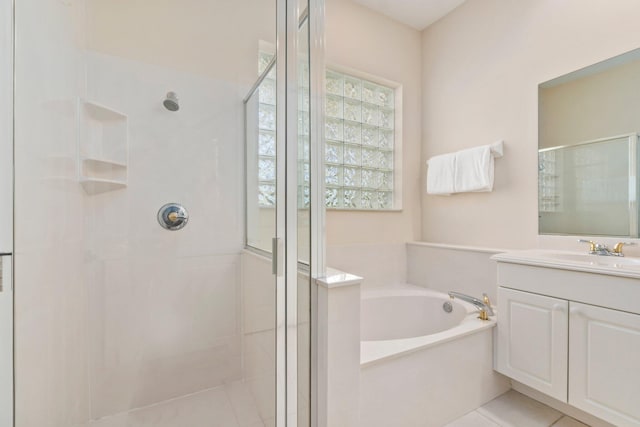 bathroom with oversized vanity, tile floors, and separate shower and tub