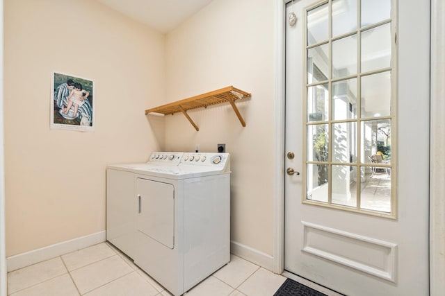 laundry area with washer and clothes dryer, electric dryer hookup, and light tile flooring