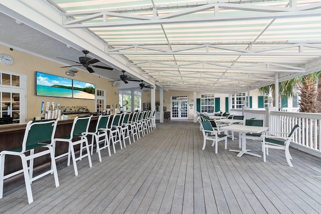 wooden deck featuring french doors, an outdoor bar, and ceiling fan