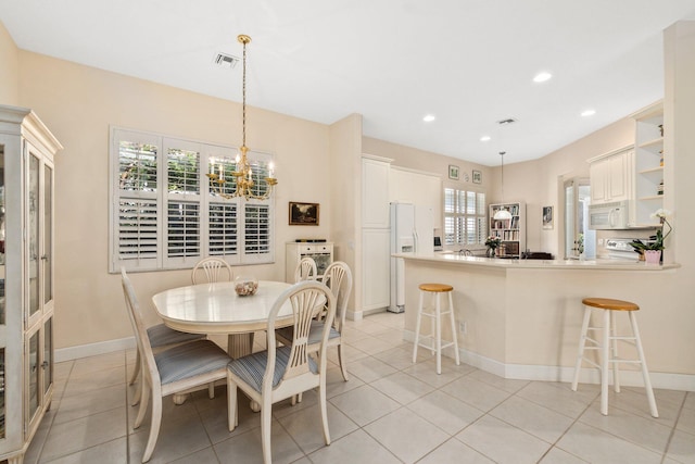 dining area featuring a wealth of natural light, an inviting chandelier, and light tile floors