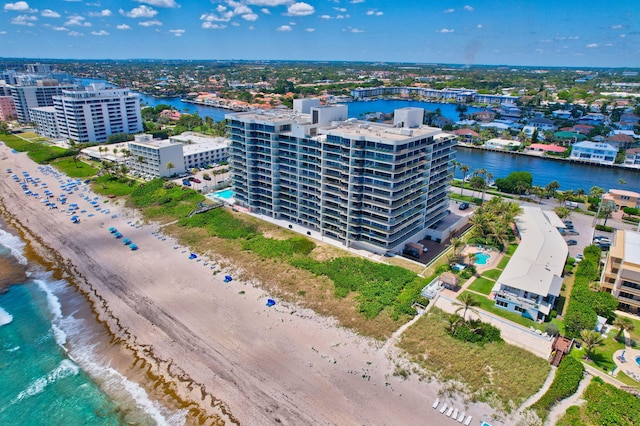 birds eye view of property with a water view and a view of the beach