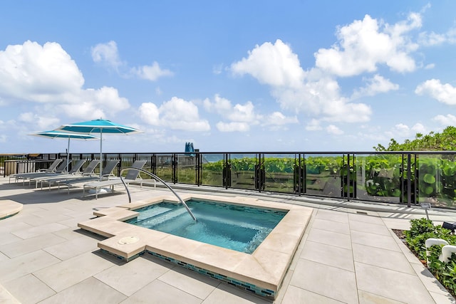 view of swimming pool featuring a patio and a community hot tub