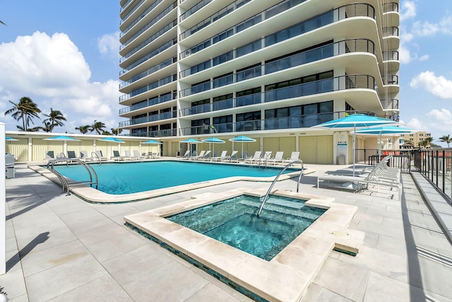 view of swimming pool featuring a community hot tub