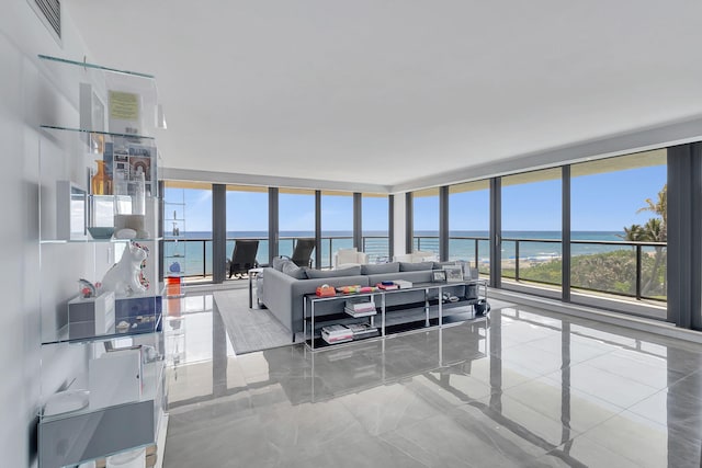 tiled living room featuring a water view