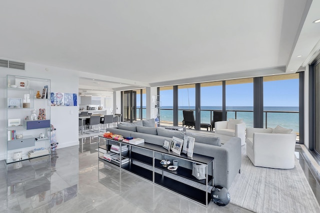 living room with light tile flooring, expansive windows, and a water view