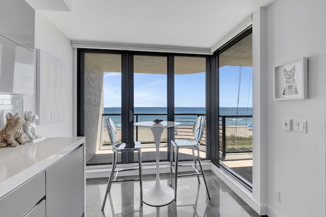 dining area featuring plenty of natural light and a water view