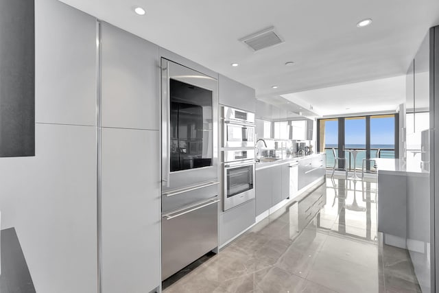 kitchen with sink and light tile flooring