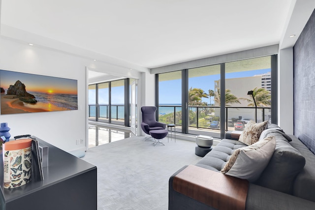 carpeted living room featuring a water view and expansive windows