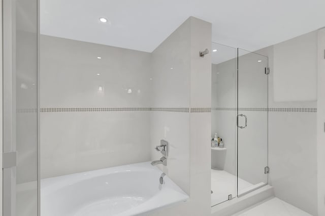 bathroom featuring tile flooring and independent shower and bath