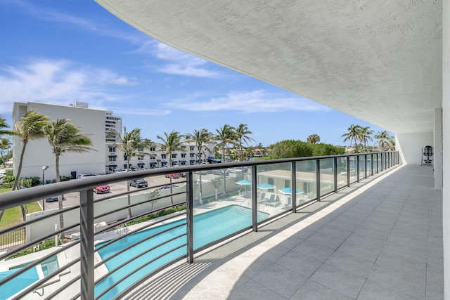 balcony featuring a community pool