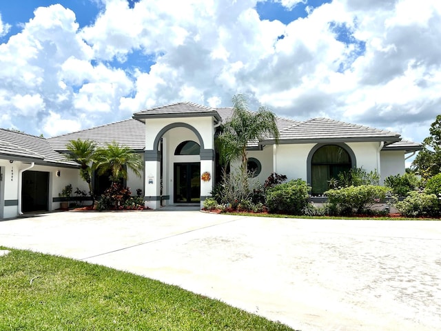 mediterranean / spanish home featuring a garage