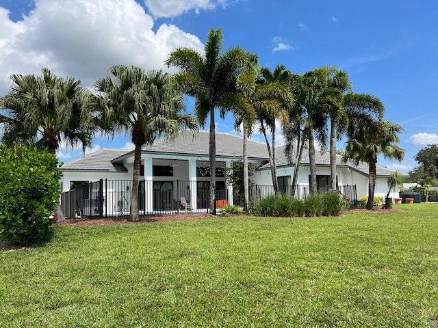 rear view of property with a yard