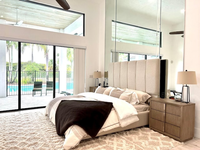 bedroom featuring access to outside and a towering ceiling