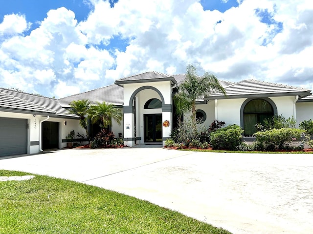 mediterranean / spanish home featuring a garage