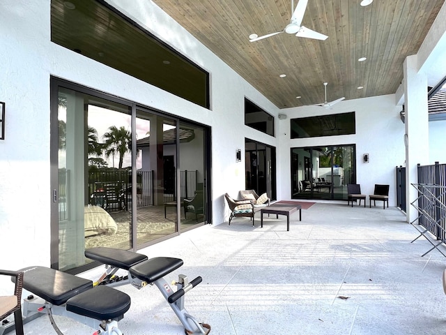 exterior space featuring ceiling fan and wood ceiling