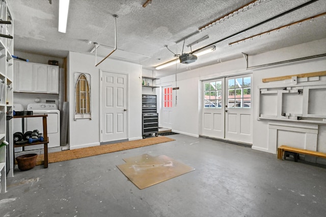 garage with washer / clothes dryer and a garage door opener