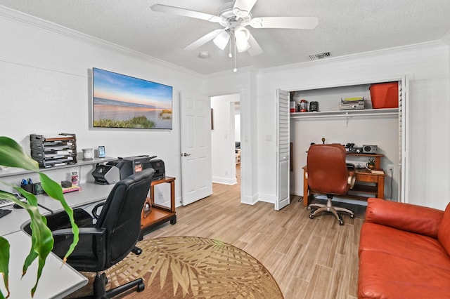 office space with ceiling fan, light hardwood / wood-style floors, ornamental molding, and a textured ceiling