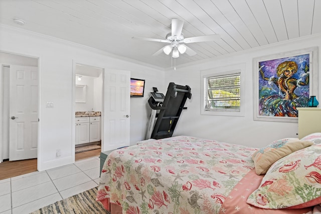 tiled bedroom with ensuite bath, ceiling fan, ornamental molding, and wood ceiling