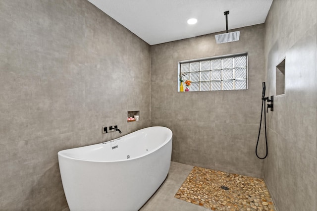 bathroom featuring separate shower and tub