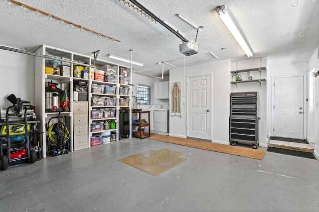 garage featuring washer and dryer and a garage door opener