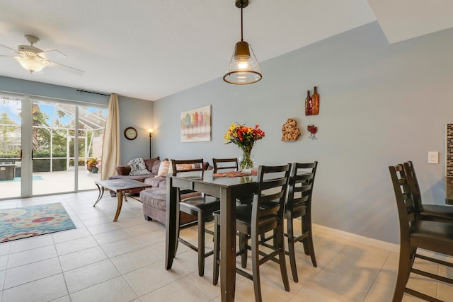 dining area with ceiling fan and light tile floors