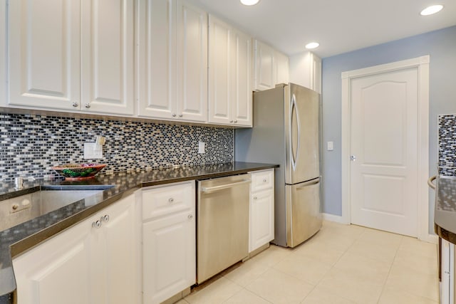 kitchen featuring backsplash, appliances with stainless steel finishes, and white cabinets