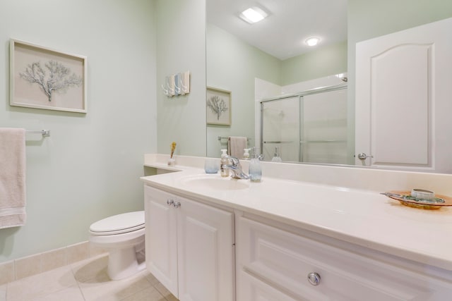 bathroom featuring tile flooring, toilet, and large vanity