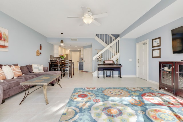 tiled living room featuring ceiling fan