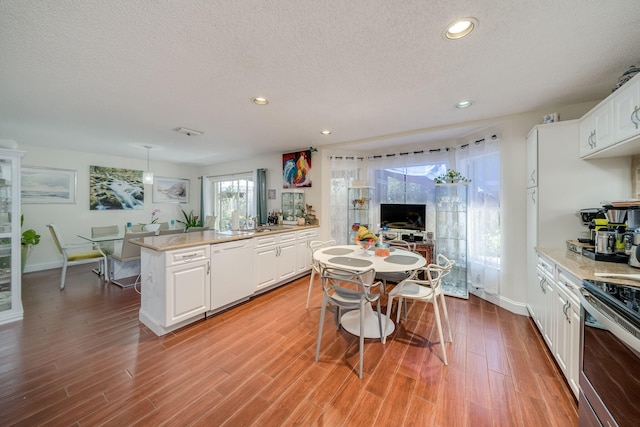 kitchen with dishwasher, white cabinets, light hardwood / wood-style flooring, and a center island