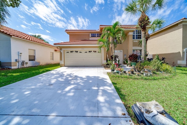 mediterranean / spanish home with a front lawn and a garage