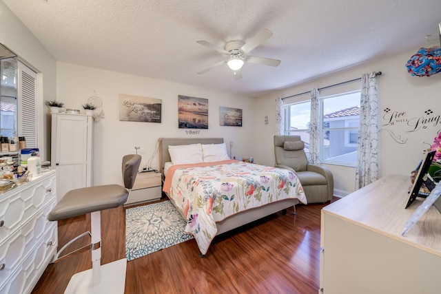 bedroom featuring a textured ceiling, wood-type flooring, and ceiling fan