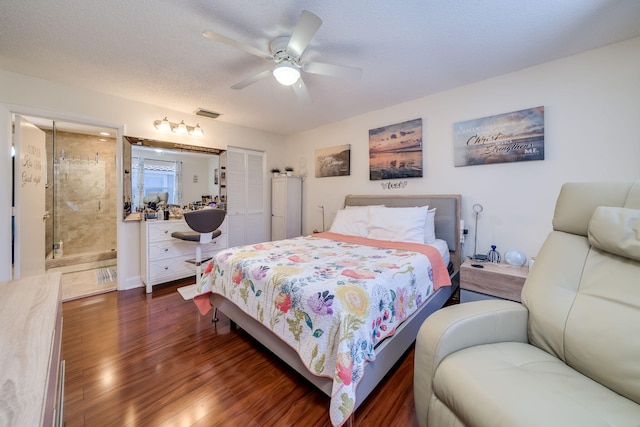 bedroom with ensuite bath, ceiling fan, a textured ceiling, and dark hardwood / wood-style flooring