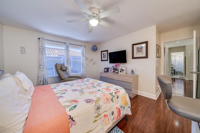 bedroom featuring dark hardwood / wood-style flooring, a textured ceiling, and ceiling fan