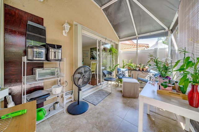 sunroom / solarium featuring vaulted ceiling