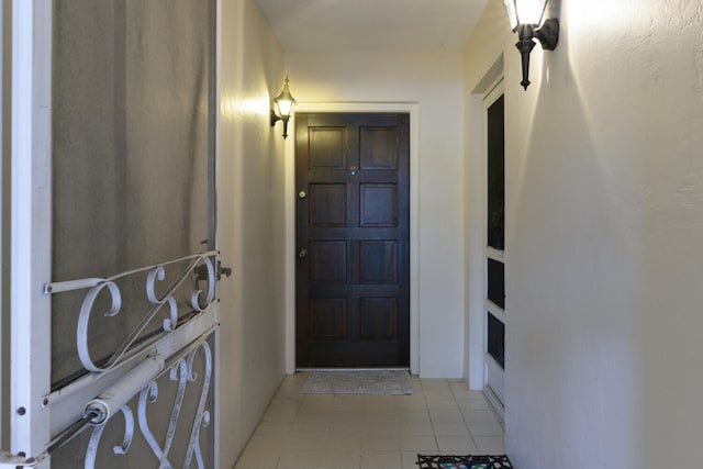 doorway to outside featuring light tile floors