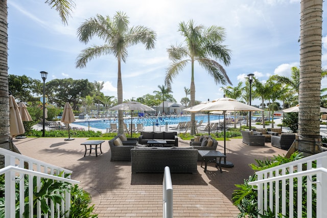 exterior space featuring outdoor lounge area and a community pool